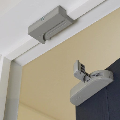 Close-up of soft closing kit installed on an interior door